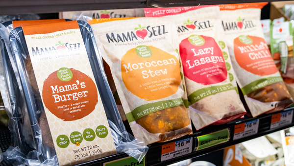 Bags of MamaSezz meals on the shelf of a local cooperative market.