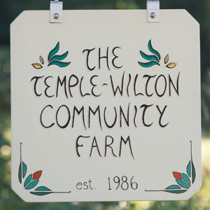 A colorful sign welcomes visitors to Temple-Wilton Community Farm