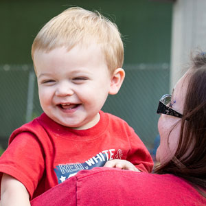 A baby laughs at Tumbleweeds Child Care Center, which survided the beginning of the pandemic with technical assistance from the New hampshire Community Loan Fund