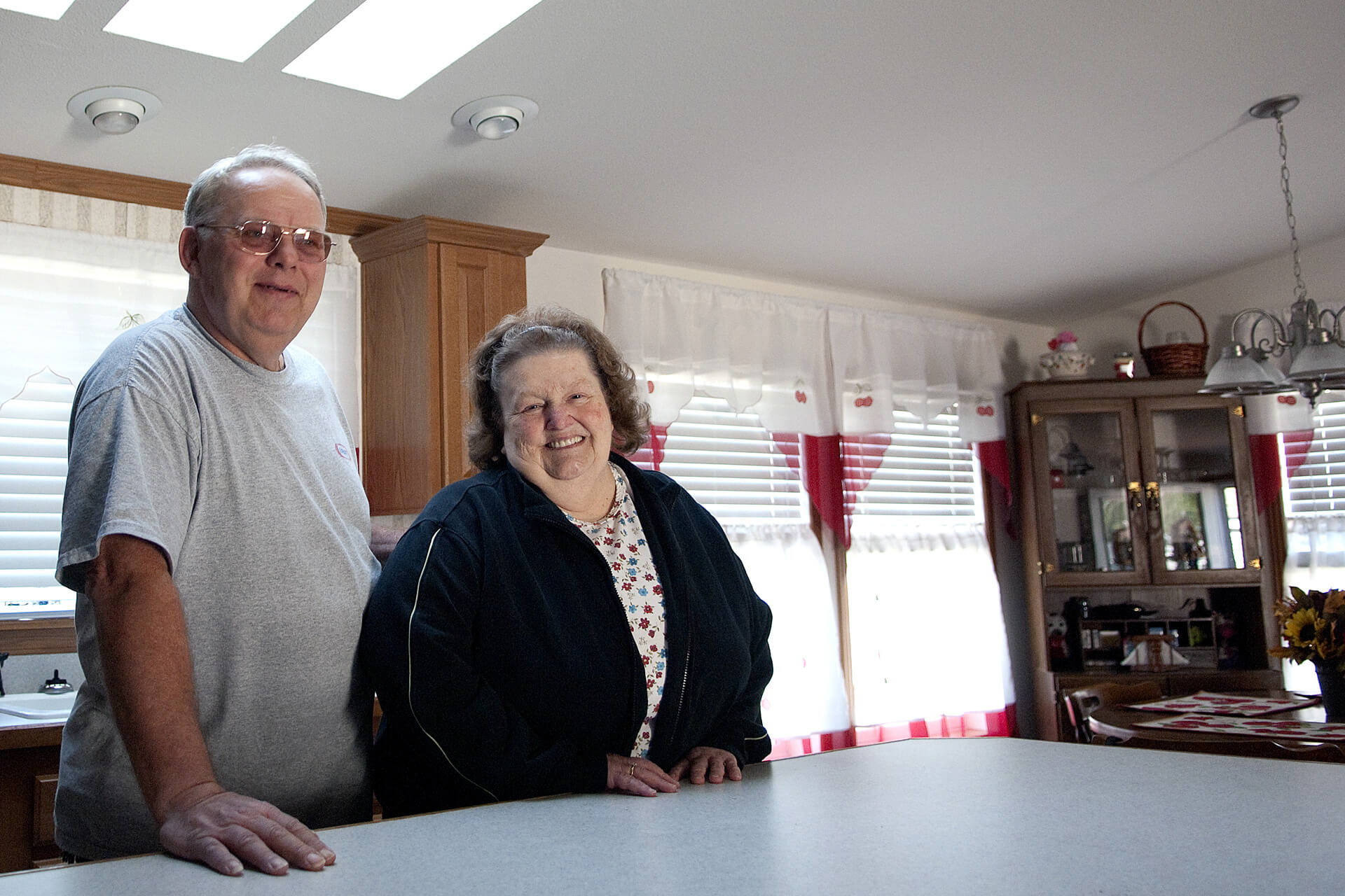 Man and woman stand at their kitchen counter
